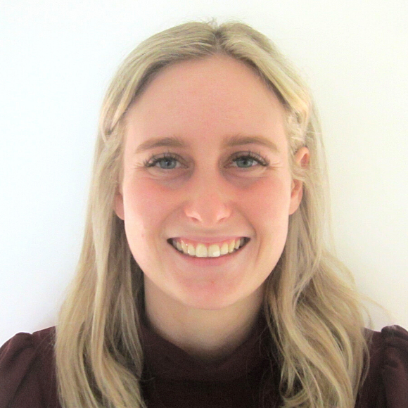 A close up photo of a smiling woman with long blonde hair